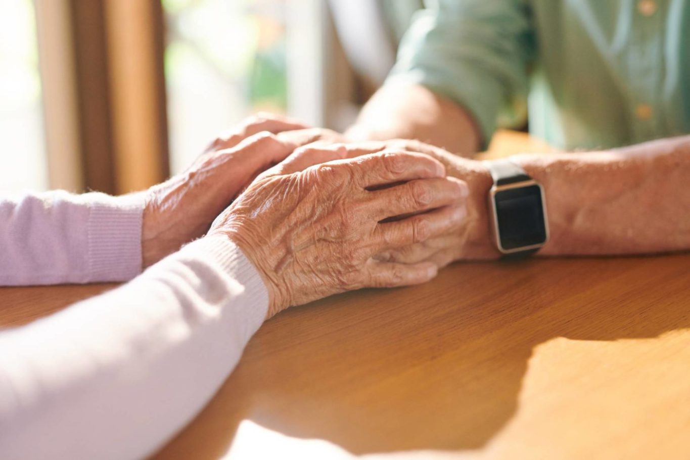 Elderly couple holding hands, exemplifying importance of resources for caregivers of dementia