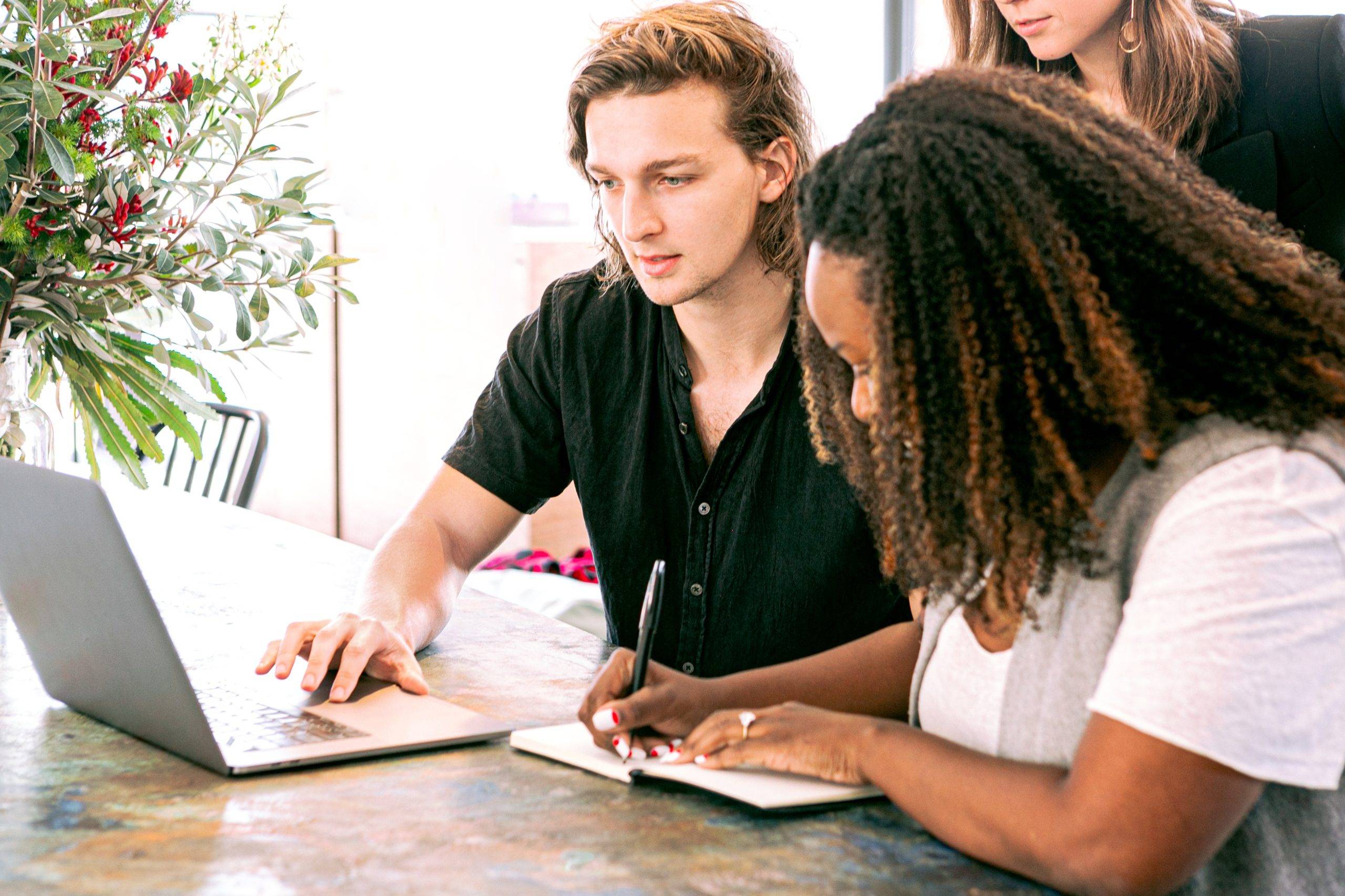 two millennials on laptop searching for resources