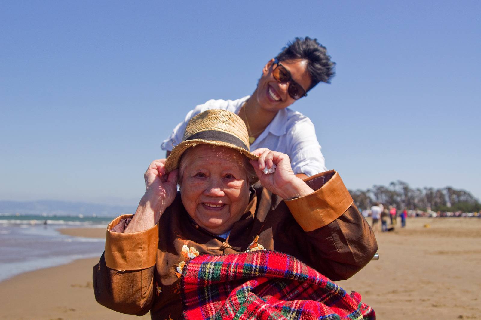 elderly woman and young woman smiling on the beach