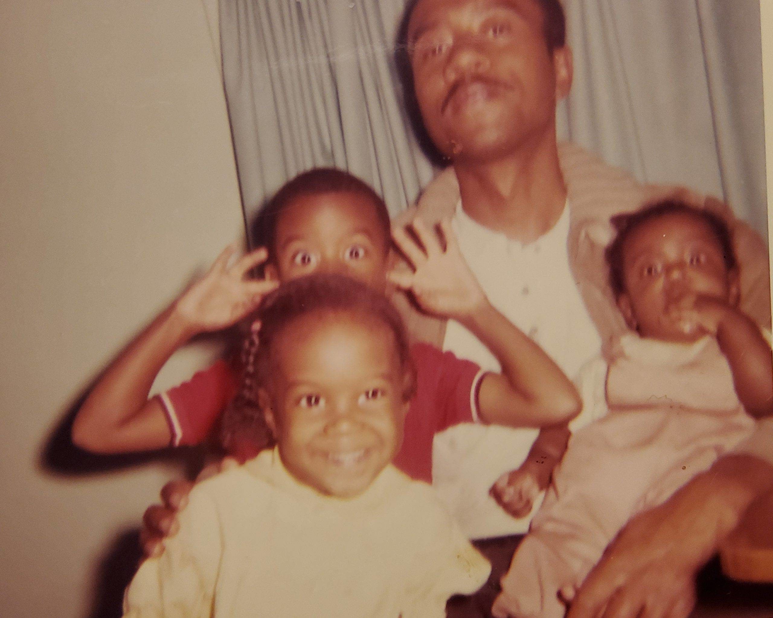 Adult man with three young kids, in their home