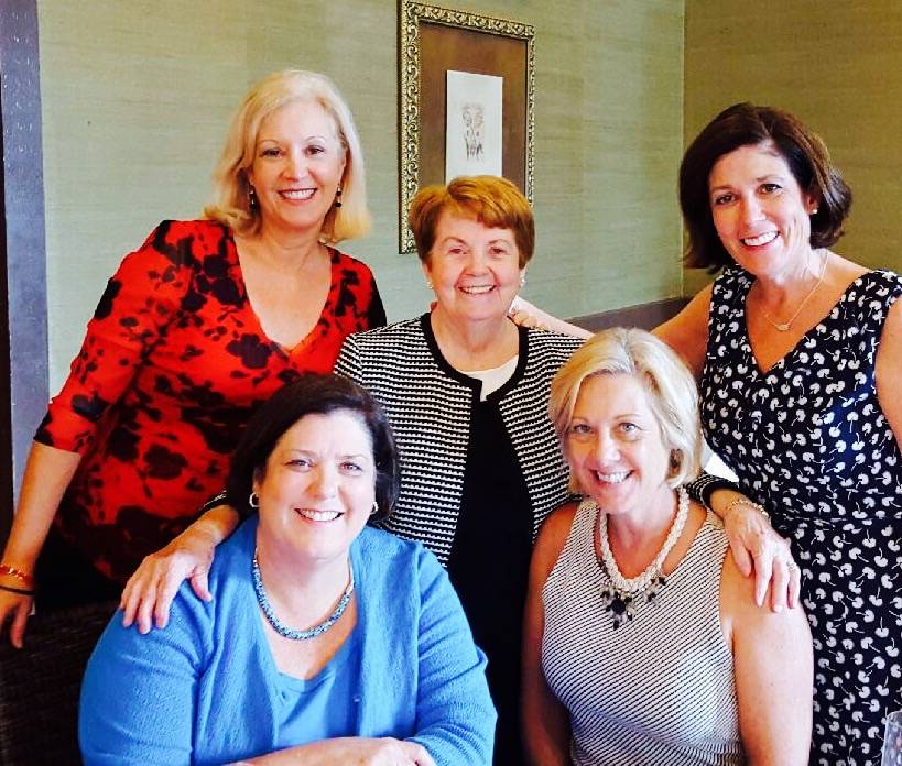 Group of women at a social gathering, smiling