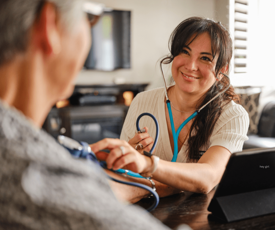 image shows a brunette healthcare provider listening to the heartbeat of an elderly patient